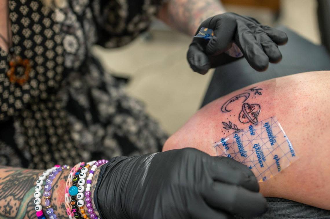 Jacque Murphy, from Des Moines, Iowa, receives a Taylor Swift theme tattoo from the song “Seven” at The Cherry Bomb Tattoo Co. on Saturday, July 8, 2023, in Lee’s Summit. The tattoo shop is holding a Taylor Swift tattoo flash event starting from July sixth to the eighth.