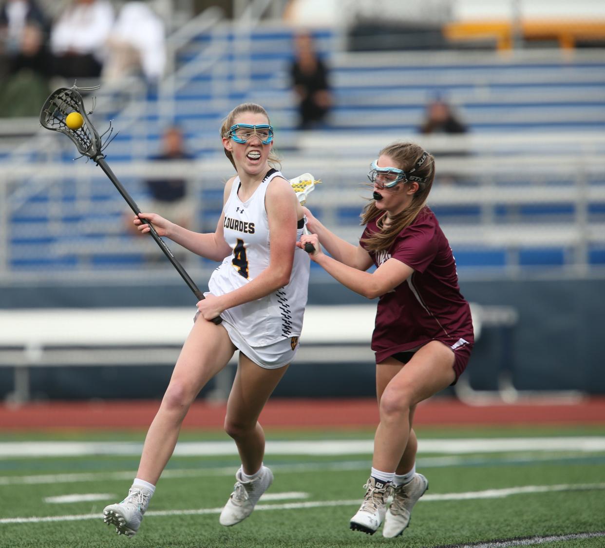 Lourdes' Deirdre Connolly moves the ball up field against Arlington during a May 3, 2022 girls lacrosse game.
