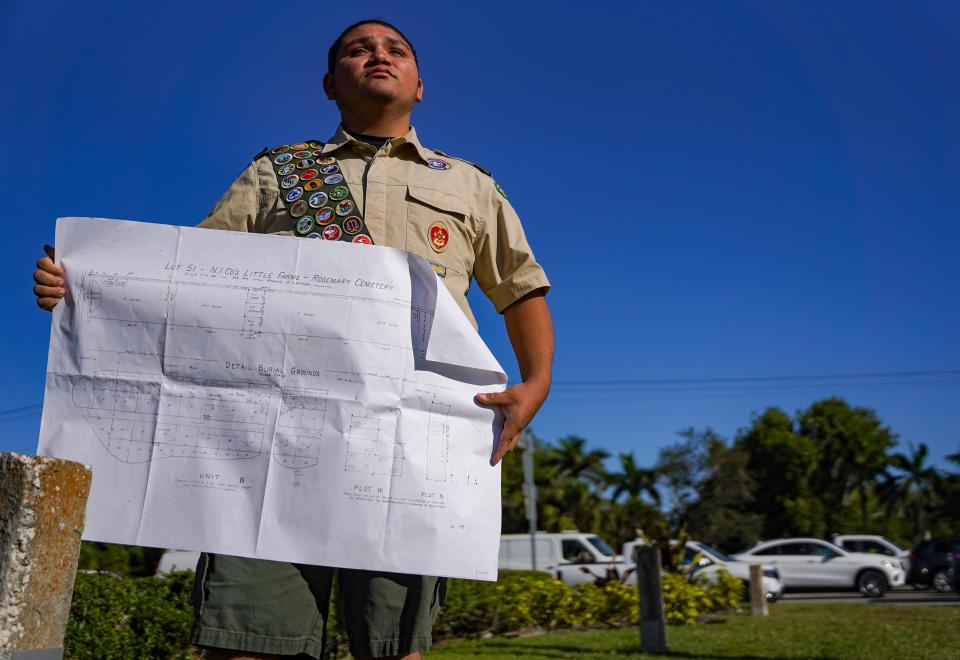 Jonathan Rodriguez, 15, poses at Plot N of the Rosemary Cemetery with a map of the entire cemetery in Naples. The site is likely home to eight unmarked African American graves and sits at the corner of Pine Ridge and Goodlette-Frank roads. He hopes to build a proper site for the graves.