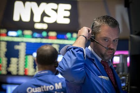 Traders work on the floor of the New York Stock Exchange July 28, 2015. REUTERS/Brendan McDermid