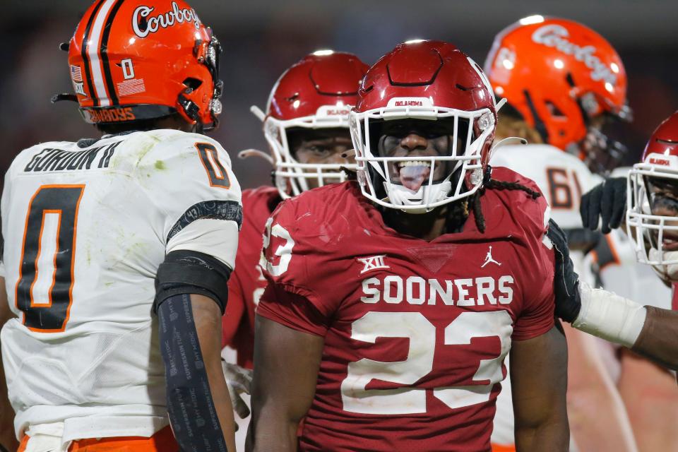 Oklahoma's DaShaun White (23) celebrates beside Oklahoma State's Ollie Gordon (0) after a sack during a Bedlam college football game between the University of Oklahoma Sooners (OU) and the Oklahoma State University Cowboys (OSU) at Gaylord Family-Oklahoma Memorial Stadium in Norman, Okla., Saturday, Nov. 19, 2022. Oklahoma won 28-13.