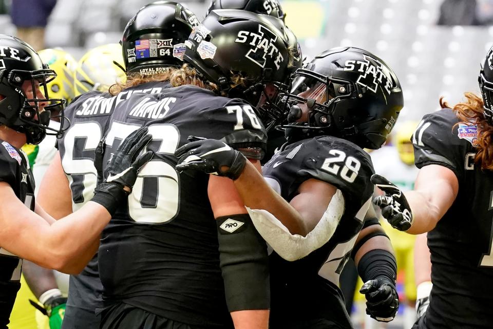 Iowa State running back Breece Hall (28) celebrates his touchdown run with offensive lineman Joey Ramos (76) during the first half of the Fiesta Bowl NCAA college football game against Oregon, Saturday, Jan. 2, 2021, in Glendale, Ariz.