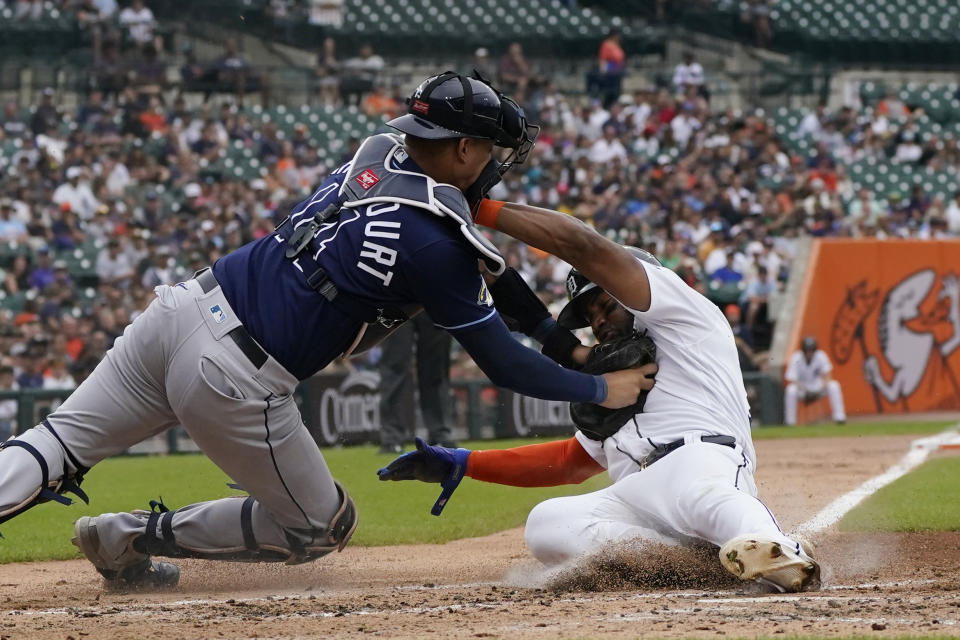 Detroit Tigers' Andy Ibanez is tagged out by Tampa Bay Rays catcher Christian Bethancourt as he tries to score from second on a single by Eric Haase during the second inning of a baseball game, Sunday, Aug. 6, 2023, in Detroit. (AP Photo/Carlos Osorio)