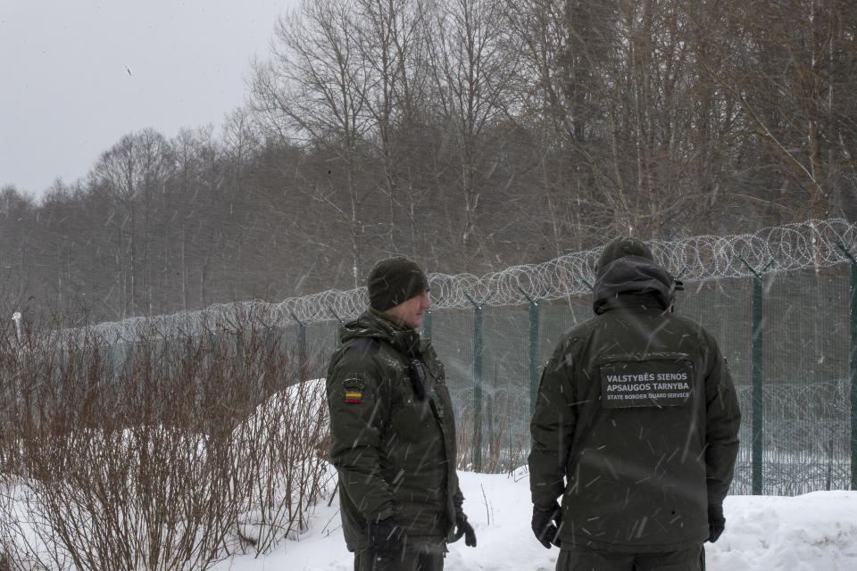 FILE - Members of the Lithuania State Border Guard Service on the border with Belarus during a visit by participants of the Conference on Border Management near the village Kurmelionys, some 40km (24 miles) east of the capital Vilnius, Lithuania, on Jan. 21, 2022. Lithuania decided Wednesday Feb. 21, 2024 to shut down two more of its six checkpoints with Belarus as of next month, amid growing tensions with its eastern neighbor, an ally of Russia, bringing the total of closed border crossings into the Baltic country to four. (AP Photo/Mindaugas Kulbis, File)