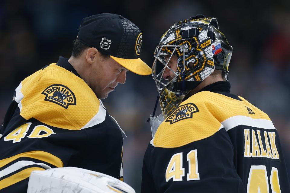 FILE - In this Thursday, Oct. 25, 2018, file photo, Boston Bruins' Jaroslav Halak (41) celebrates with Tuukka Rask after defeating the Philadelphia Flyers during an NHL hockey game in Boston. Managing top goaltenders’ schedules is the NHL’s version of load management. Each of the past five Stanley Cup-winning goalies started fewer than 60 games in the regular season, along with three of the past five runners up. (AP Photo/Michael Dwyer, File)