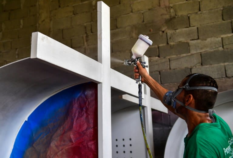 An inmate of La Joya prison in Panama works on painting a cross that will be used during Pope Francis's visit to Panama for World Youth Day celebrations in January