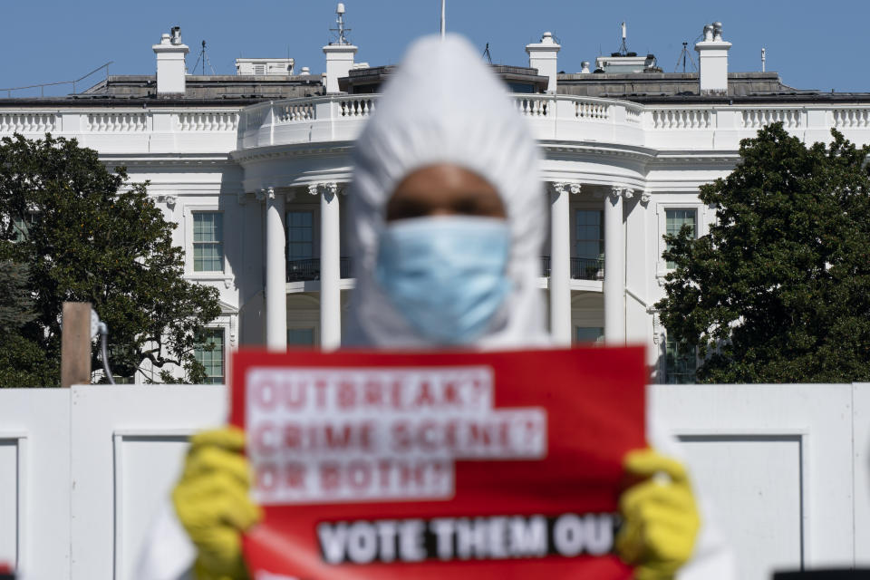 A person with MoveOn.org Political Action protests the ongoing outbreak of coronavirus in the White House, Thursday, Oct. 8, 2020, outside the White House in Washington. (AP Photo/Jacquelyn Martin)