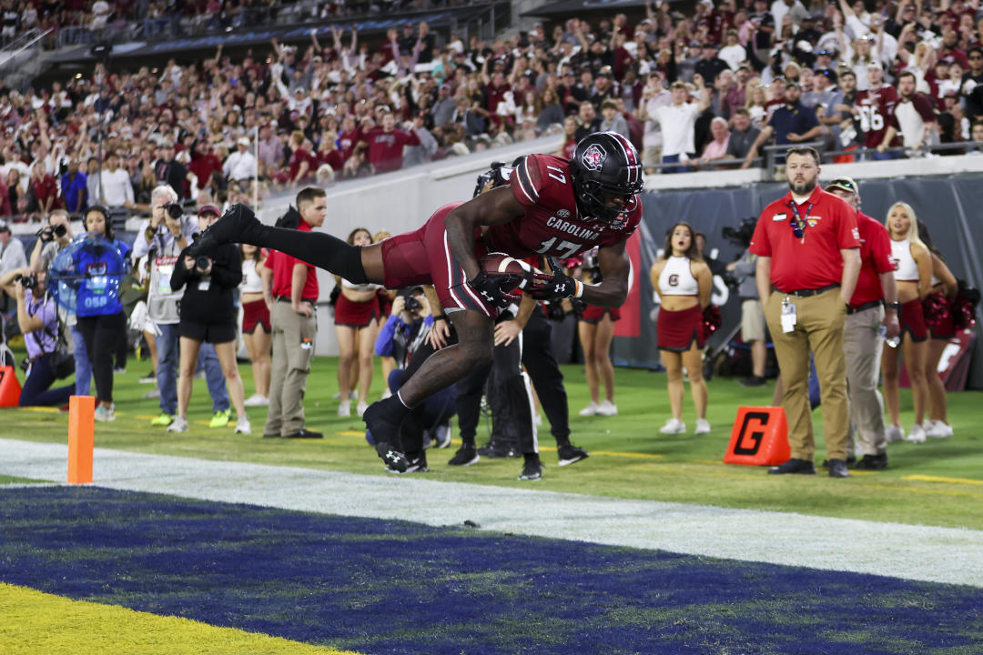 JACKSONVILLE, FLORIDA - DECEMBER 30: Xavier Legette #17 of the South Carolina Gamecocks catches a pass for a touchdown against the Notre Dame Fighting Irish during the second half of the TaxSlayer Gator Bowl at TIAA Bank Field on December 30, 2022 in Jacksonville, Florida. (Photo by James Gilbert/Getty Images)