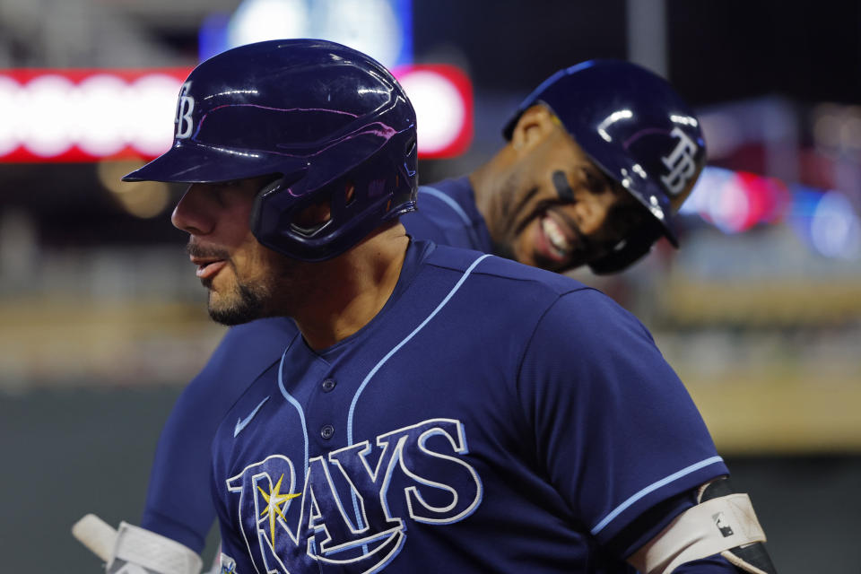 Tampa Bay Rays' Rene Pinto, left, celebrates his solo home run against the Minnesota Twins next to Yandy Diaz during the fifth inning of a baseball game Tuesday, Sept. 12, 2023, in Minneapolis. (AP Photo/Bruce Kluckhohn)