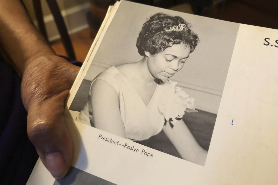 In this March 4, 2020 photo, Roslyn Pope shows her Spelman College yearbook at her home in Atlanta. As a 21-year-old Spelman senior in March 1960, Pope wrote "An Appeal for Human Rights," a document that made the case for the Atlanta Student Movement, a nonviolent campaign of boycotts and sit-ins by black college students that protested racial segregation in education, jobs, housing, voting, hospitals, movies, concerts, restaurants and law enforcement. (AP Photo/Michael Warren)
