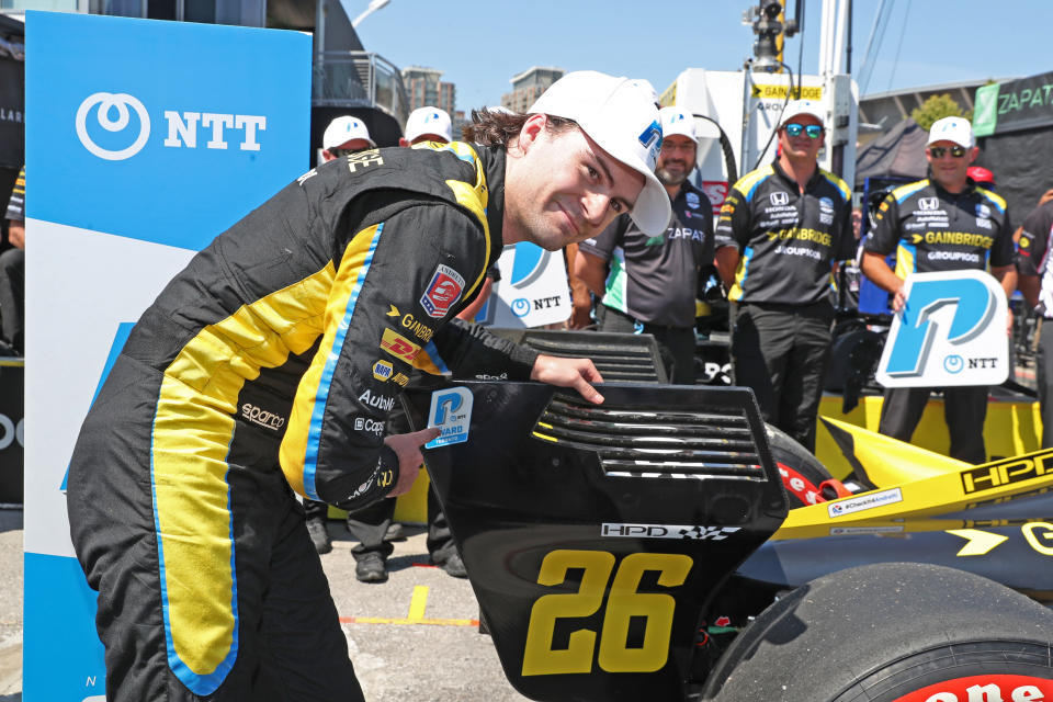 TORONTO, ON - JULY 16: NTT IndyCar series driver Colton Herta (26) places the P1 sticker on his car for qualifying the fastest and winning the pole award for the Honda Indy Toronto on July 16, 2022 on the Streets of Toronto. (Photo by Brian Spurlock/Icon Sportswire via Getty Images)