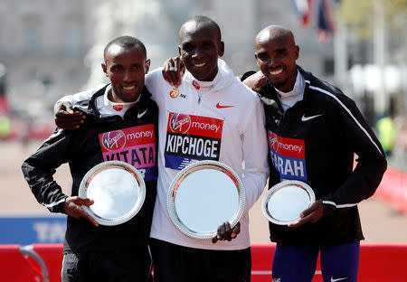 FILE PHOTO: London Marathon Winner Kenya's Eliud Kipchoge with second placed Ethiopia's Tola Shura Kitata and third placed Britain's Mo Farah in London, Britain - April 22, 2018. REUTERS/Paul Childs/File Photo