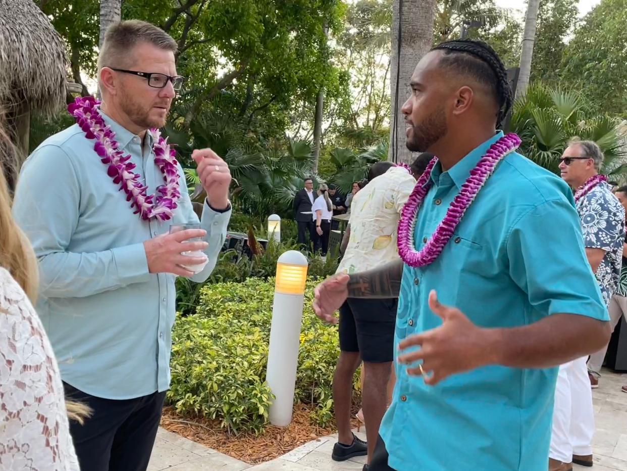 Dolphins QB Tua Tagovailoa talks with QB coach Darrell Bevell at last week's Luau with Tua.