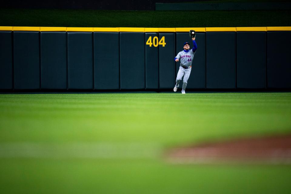 New York Mets outfielder Harrison Bader (44) catches a fly ball in the fifth inning of the MLB baseball game between the Cincinnati Reds and New York Mets at Great American Ball Park in Cincinnati on Friday, April 5, 2024.