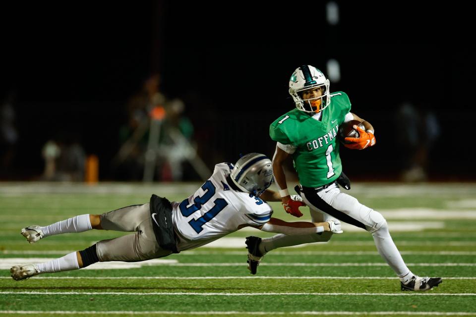 Dublin Coffman's Amari Valerio-Hudson tries to elude Olentangy Liberty’s Antonio Kish (31) during Friday's game.