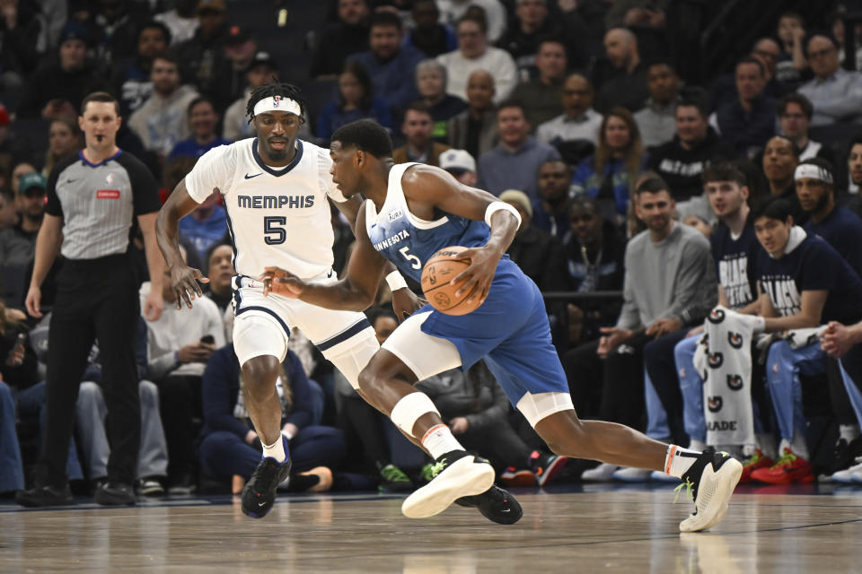 Minnesota Timberwolves guard Anthony Edwards, right, drives past Memphis Grizzlies forward Vince Williams Jr. during the first half of an NBA basketball game Wednesday, Feb 28, 2024, in Minneapolis. (AP Photo/Craig Lassig)