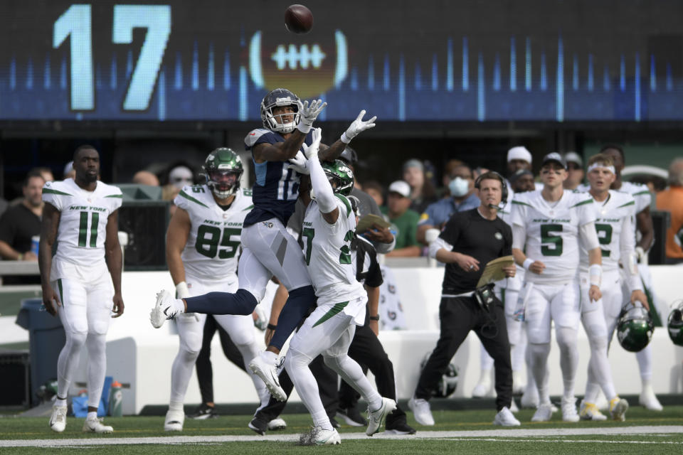 New York Jets cornerback Isaiah Dunn, right, breaks up a pass to Tennessee Titans wide receiver Josh Reynolds, left, during the second half of an NFL football game, Sunday, Oct. 3, 2021, in East Rutherford, N.J. (AP Photo/Bill Kostroun)