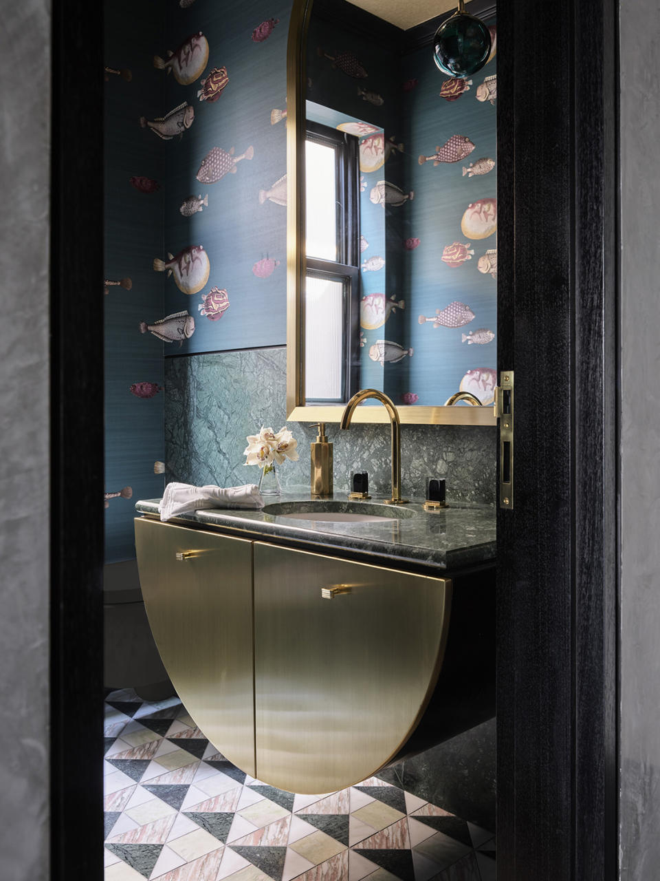 bathroom with brass vanity under the sink