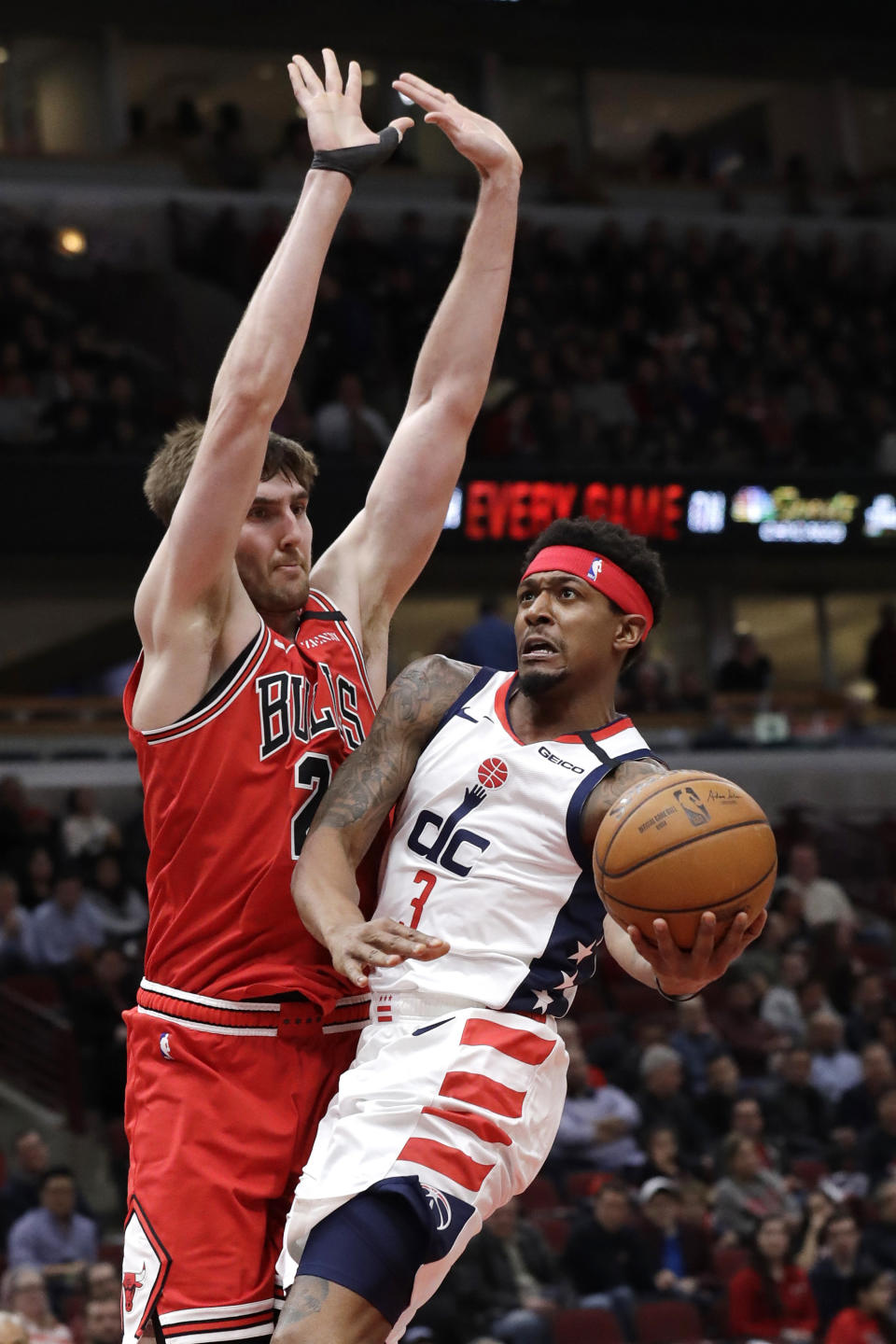 Washington Wizards guard Bradley Beal, right, drives to the basket against Chicago Bulls forward Luke Kornet during the first half of an NBA basketball game in Chicago, Wednesday, Jan. 15, 2020. (AP Photo/Nam Y. Huh)