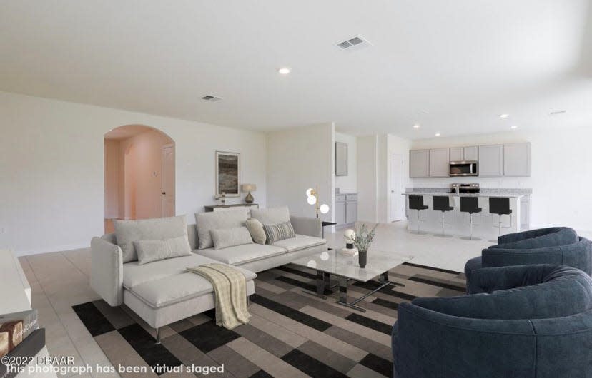 The open-living area has been virtually staged to give potential buyers an idea of what it would be like to live in this brand-new home.