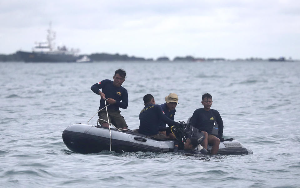 Indonesian Navy divers continue their search for wreckage of the crashed Sriwijaya Air passenger jet in the Java Sea, near Jakarta, Indonesia, Tuesday, Jan. 12, 2021. Indonesian navy divers were searching through plane debris and seabed mud Tuesday looking for the black boxes of a Sriwijaya Air jet that nosedived into the Java Sea over the weekend with 62 people aboard. (AP Photo/Tatan Syuflana)