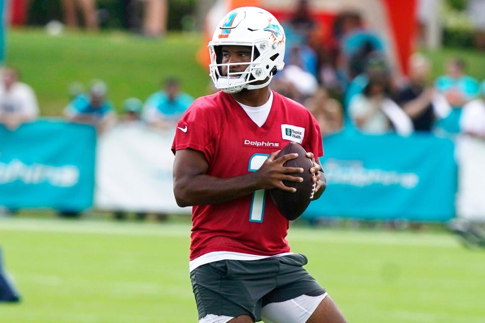 Miami Dolphins quarterback Tua Tagovailoa (1) takes part in drills at the NFL football team's practice facility, Saturday, July 30, 2022, in Miami Gardens, Fla.