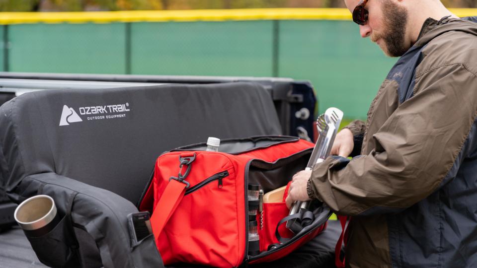 This camping cooler comes with various cookout tools perfect for the outdoors lover.