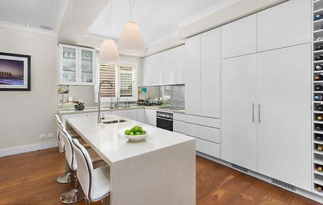 The contemporary kitchen has clean white cupboard. Photo: Ray White