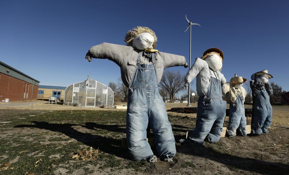 In this Thursday, Dec. 12, 2013 photo, scarecrows stand in a dormant garden at the Walton 21st Century Rural Life Center in Walton, Kan. Located in a small farming community, the school faced closing before re-establishing itself as an agriculture-focused charter school and more than doubling enrollment. (AP Photo/Charlie Riedel)