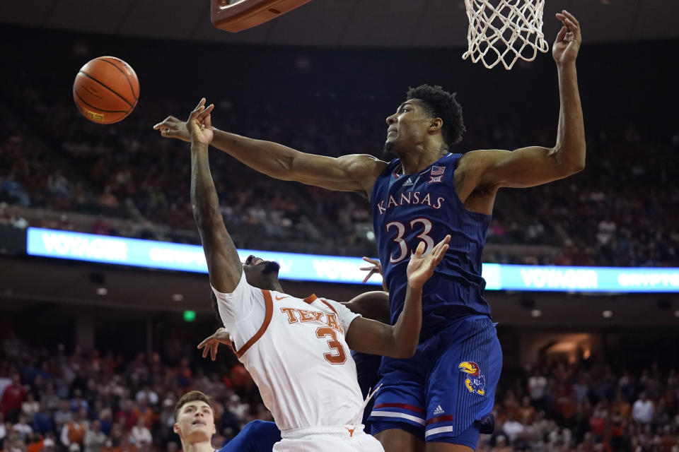 Texas guard Courtney Ramey (3) is blocked by Kansas forward David McCormack (33) during the second half of an NCAA college basketball game, Monday, Feb. 7, 2022, in Austin, Texas. (AP Photo/Eric Gay)