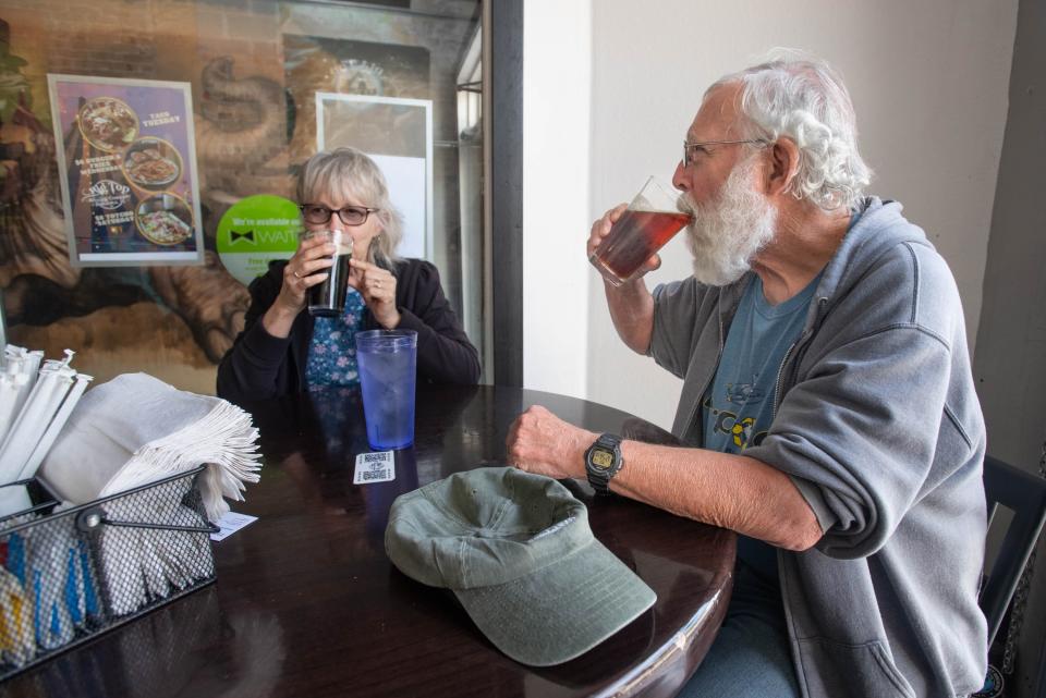 Linda and George Statler, of Asheville, North Carolina, enjoy beers at Big Top Brewing Company in downtown Pensacola on Monday, March 13, 2023.