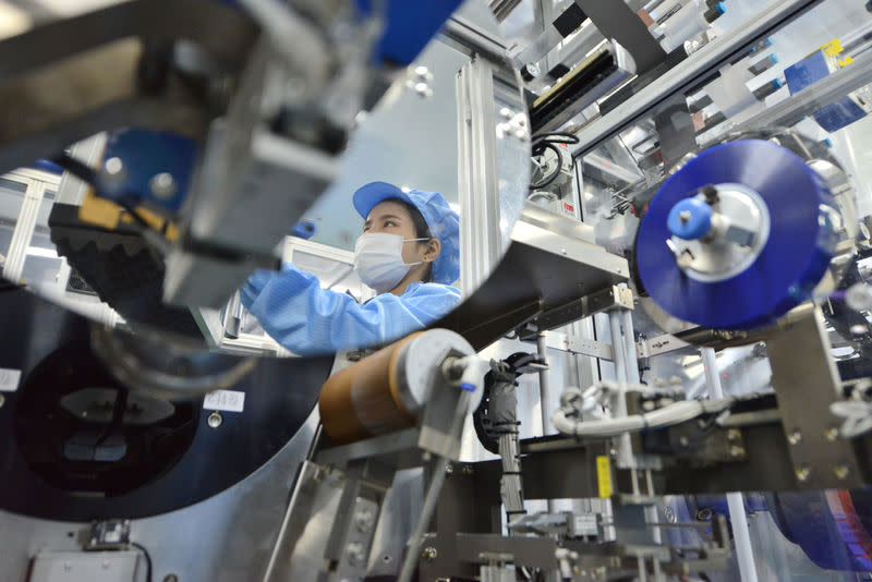 The reflection of a worker is seen at the production line of lithium-ion batteries for electric vehicles (EV) at a factory in Huzhou, Zhejiang province, China August 28, 2018. REUTERS/Stringer