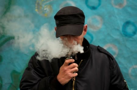 FILE PHOTO: A man poses for a picture, as he vapes at home in La Paz,