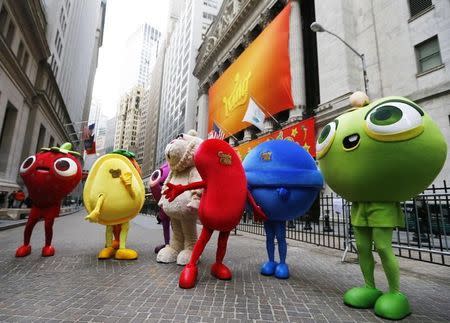 Mascots dressed as characters from the mobile video game "Candy Crush Saga" pose outside the New York Stock Exchange March 26, 2014. REUTERS/Brendan McDermid