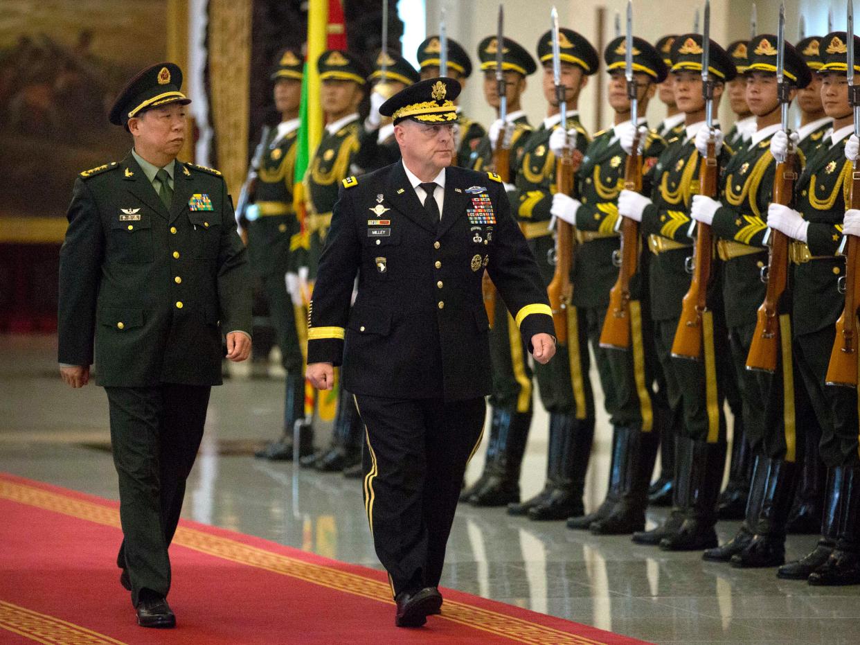 China’s People’s Liberation Army General Li Zuocheng and then-US Army Chief of Staff General Mark Milley review an honour guard during a welcome ceremony at the Bayi Building in Beijing on August 16, 2016 (AFP via Getty Images)