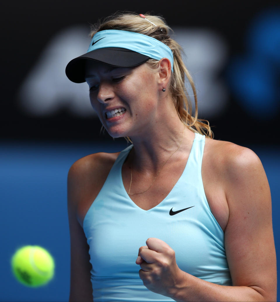 Maria Sharapova of Russia celebrates a point won against Dominika Cibulkova of Slovakia during their fourth round match at the Australian Open tennis championship in Melbourne, Australia, Monday, Jan. 20, 2014.(AP Photo/Aaron Favila)