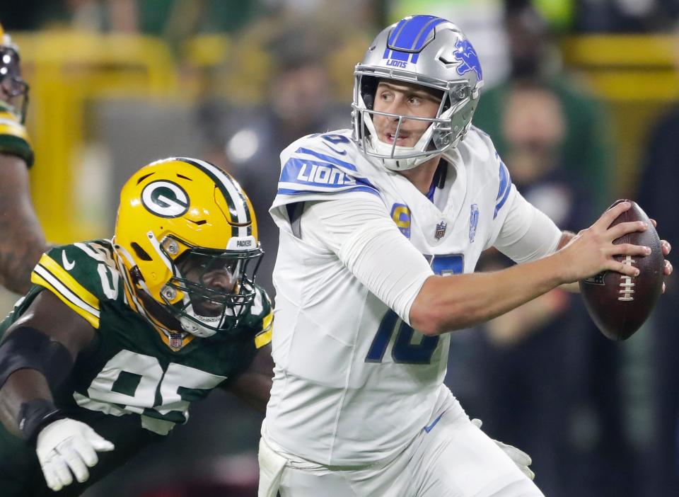Green Bay Packers defensive tackle Devonte Wyatt (95) chases Detroit Lions quarterback Jared Goff (16) during their football game Thursday, September 28, 2023, at Lambeau Field in Green Bay, Wis.