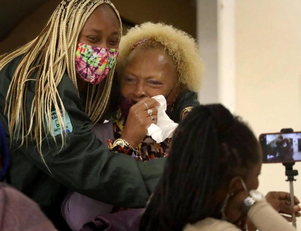 On Thursday, March 11, 2021 displaced Annie Coleman Project resident,Tammy Wesby, 53, center, is comforted by her daughter, Tamara Futch, 37, left, after Wesby’s emotional remarks during graduation ceremony held by Circle of Brotherhood after completing the Miami-Dade’s Housing Department funded assistance program in Miami, Florida.