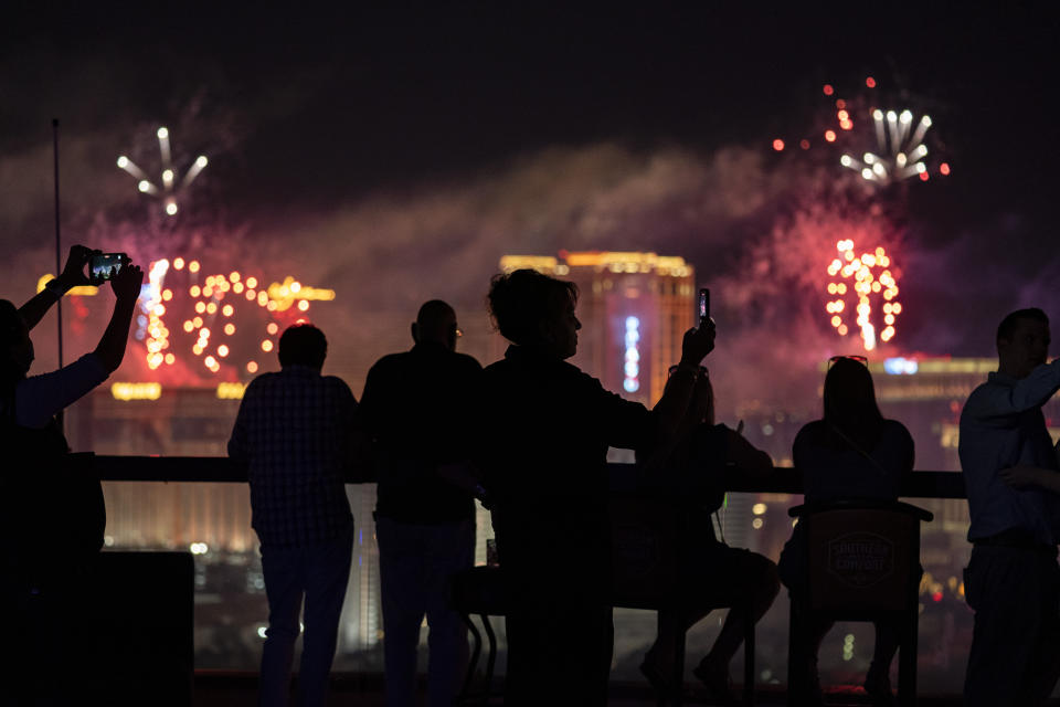 FILE - In this Sunday, July 4, 2021, file photo, spectators watch as fireworks explode over the Las Vegas Strip during a 4th of July Fireworks show in Las Vegas. COVID-19 cases have doubled over the past three weeks, driven by the fast-spreading delta variant, lagging vaccination rates in some states and Fourth of July gatherings. The five states with the biggest two-week jump in cases per capita all had lower rates, Missouri, 45.9%; Arkansas, 43%, Nevada, 50.9%, Louisiana, 39.2% and Utah, 49.5%. (AP Photo/John Locher, File)