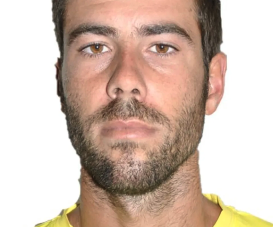 Tomas Gimeno wears a yellow shirt against a white background. 