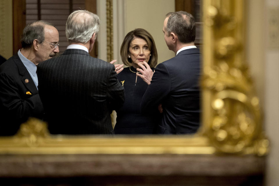 House Speaker Nancy Pelosi of Calif., center, speaks with House Intelligence Committee Chairman Adam Schiff, D-Calif., right, House Foreign Affairs Committee Chairman Eliot Engel, D-N.Y., left, and House Ways and Means Committee Chairman Richard Neal, D-Mass., second from left, in a private room just off the House floor after the House votes to impeach President Donald Trump, Wednesday, Dec. 18, 2019, on Capitol Hill in Washington. (AP Photo/Andrew Harnik)