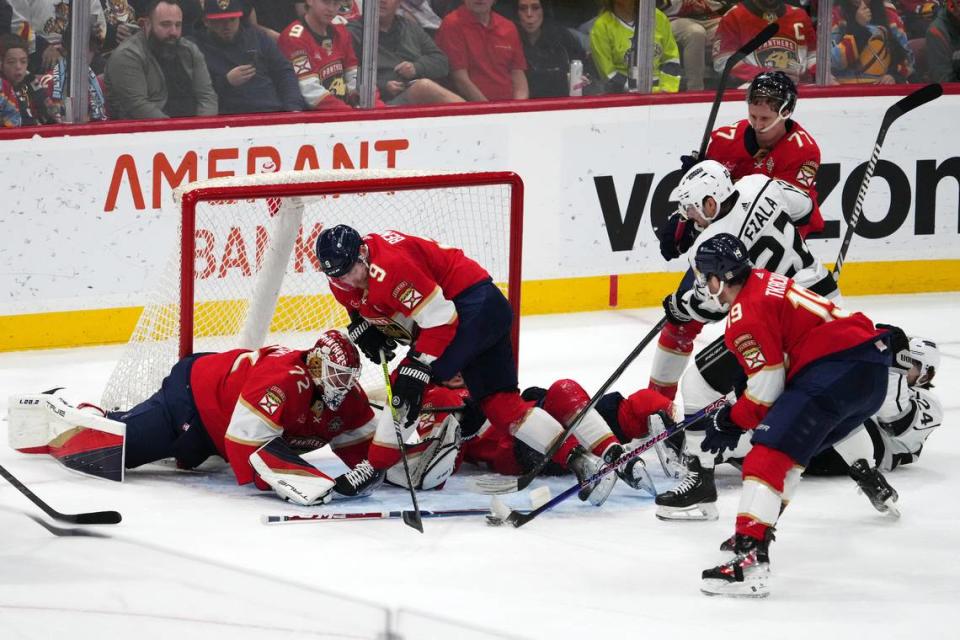 Jan 11, 2024; Sunrise, Florida, USA; Florida Panthers left wing Matthew Tkachuk (19) clears the puck in front of Los Angeles Kings left wing Kevin Fiala (22), center Sam Bennett (9) and goaltender Sergei Bobrovsky (72) during the second period at Amerant Bank Arena.