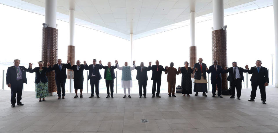 In this photo provided by Prime Minister of India Narendra Modi's twitter handle, leaders of the Forum for India-Pacific Islands Cooperation (FIPIC) link their hands in Port Moresby, Papua New Guinea, Monday, May 22, 2023. Modi is meeting with Pacific leaders to discuss better cooperation. (Prime Minister of India Narendra Modi's twitter handle via AP Photo)