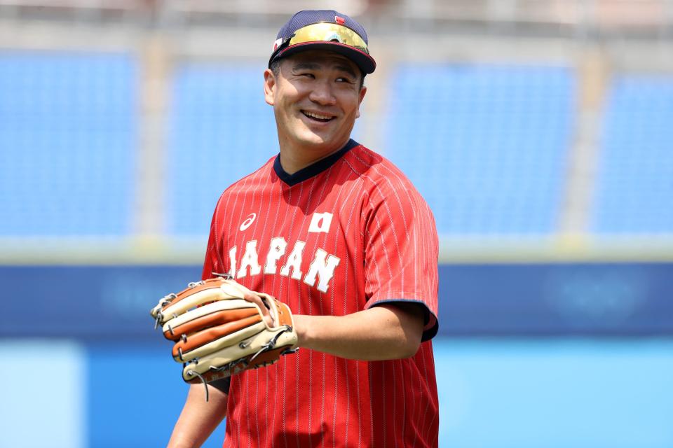 Masahiro Tanaka warms up before Japan's game against Mexico during the opening round of the Olympic baseball tournament.