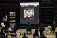 Seattle Seahawks quarterback Russell Wilson, left on the video screen, and his wife, Ciara, speak to Stanford players as they honor Wilson's sister Anna Wilson, seated center, and other seniors after Stanford defeated California in an NCAA college basketball game in Stanford, Calif., Sunday, Feb. 28, 2021. (AP Photo/Jeff Chiu)