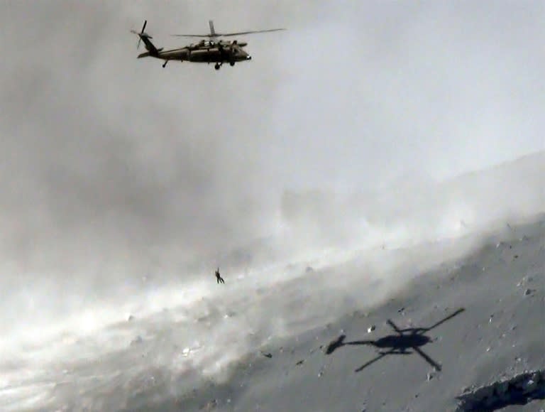 A helicopter from Japan's Self Defence Force lifts a survivor during a 2014 mountain rescue in Nagano prefecture, central Japan