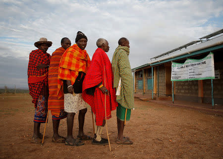 Samburu tribesmen wait to vote in front of a polling station during elections in a village near Baragoy, Kenya August 8, 2017. REUTERS/Goran Tomasevic