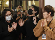 Pianist Bruce (Xiaoyu) Liu, center, of Canada reacts after being named as the winner of the 40,000-euro ($45,000) first prize in the 18th Frederic Chopin international piano competition, a prestigious event that launches pianists’ world careers. Almost 90 pianists from around the globe took part in the 18th edition of the competition that was postponed from 2020 due to the pandemic. (AP Photo/Czarek Sokolowski)