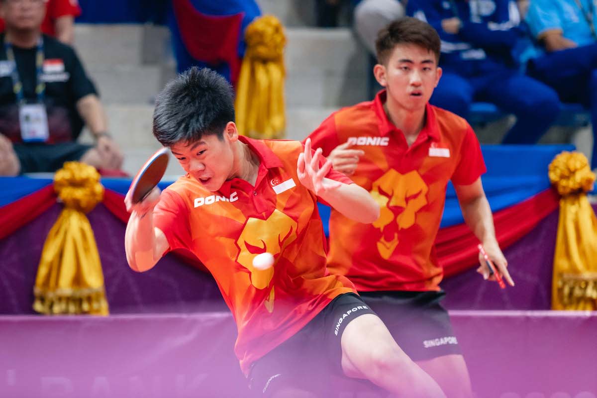 Singapore paddlers Izaac Quek (left) and Koen Pang in action in the men's doubles final at the 2023 SEA Games. (PHOTO: SNOC/Eng Chin An)