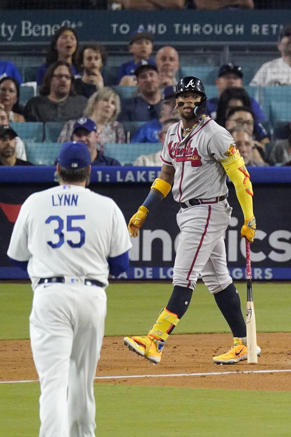 Atlanta Braves' Ronald Acuna Jr., right, heads to first after hitting a grand slam as Los Angeles Dodgers starting pitcher Lance Lynn watches during the second inning of a baseball game Thursday, Aug. 31, 2023, in Los Angeles. (AP Photo/Mark J. Terrill)